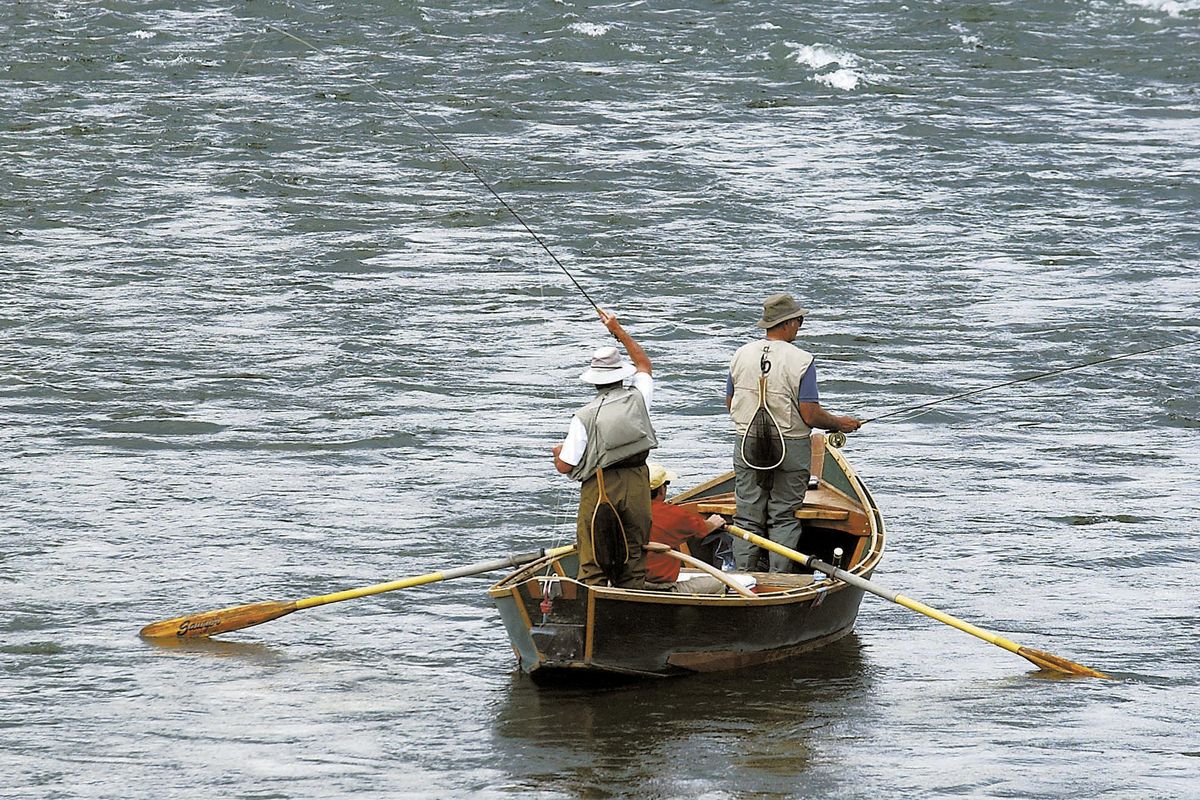 FILE - In this Sept. 9, 2004, file photo, two fly fishermen and an oarsman test their angling skills as they float down the Yellowstone River near Pine Creek, Mont., fishing access. Montana is closing a  183-mile stretch of the Yellowstone River to all recreational activities to prevent the spread of a parasite that is believed to have killed tens of thousands of fish, authorities said Friday. (Garrett Cheen / Associated Press)