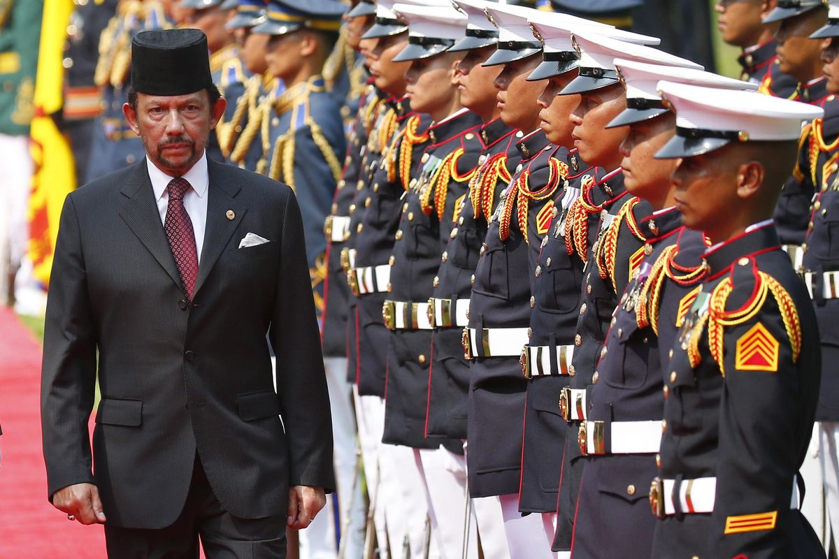Sultan Hassanal Bolkiah of Brunei reviews the troops during a welcoming ceremony for the sultan Thursday at Malacanang Palace in Manila, Philippines. Bolkiah arrived Wednesday for a state visit and to attend the annual ASEAN Leaders