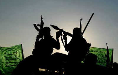 
Masked Palestinian militants from Hamas ride on a truck during a rally in the evacuated Jewish settlement of Dugit in the northern Gaza Strip Tuesday. They were celebrating Israel's withdrawal from Gaza. 
 (Associated Press / The Spokesman-Review)