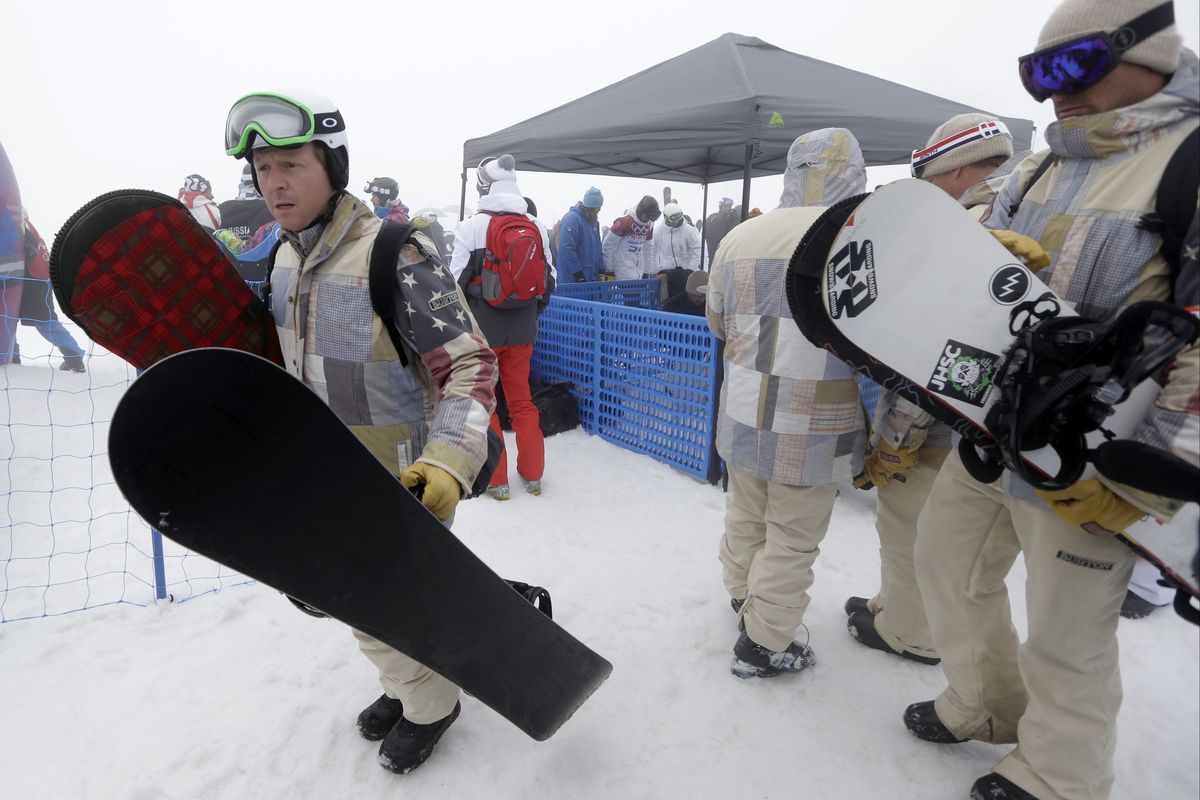 Nate Holland of Sandpoint, left, wasn’t disappointed when officials postponed the men’s snowboard cross because of fog. (Associated Press)