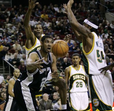 
Tim Duncan, passing ball, scored 26 points against Seattle and helped get Spurs off to a franchise-best 12-2 start.Associated Press
 (Associated Press / The Spokesman-Review)