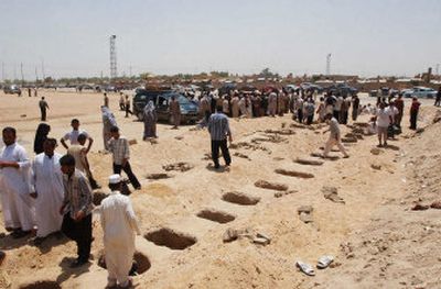 
Graves are dug for victims of Saturday's massive car bomb at an outdoor market in Baghdad following a funeral procession Sunday in Najaf, Iraq. At least 66 people were killed. 
 (Associated Press / The Spokesman-Review)