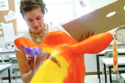 
Ana Kendall paints on a fiberglass cow  as part of an art competition sponsored by Safeway and Lucerne dairy products. 
 (JESSE TINSLEY photos / The Spokesman-Review)
