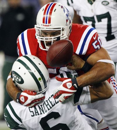 Patriots defensive end Rob Ninkovich, top, sacks Jets QB Mark Sanchez to clinch win. (Associated Press)