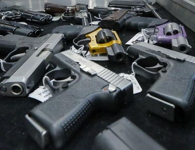 Handguns are displayed on a vendor’s table at an annual gun show in Albany, New York on Jan. 26, 2013. (Philip Kamrass / AP)