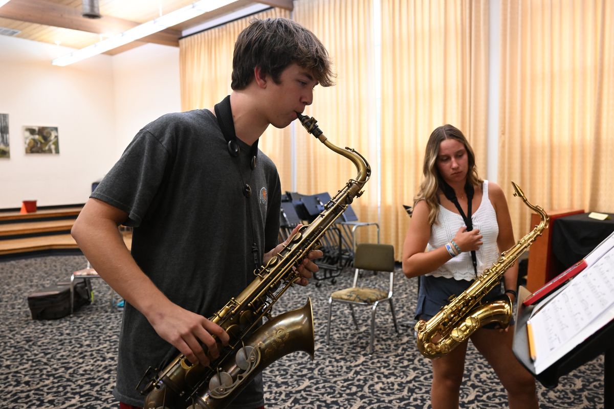 Saxophonist Carson Johnson, left, takes over on his tenor saxophone after Ariana Kasimov finishes her solo during a All-City Jazz Ensembles rehearsal Thursday, Aug. 3, 2023 at the Holy Names Music Center in Spokane, Washington. The program helps high school and middle school musicians advance in the world of jazz by forming small combos and giving them a chance to perform.  (Jesse Tinsley/The Spokesman-Review)