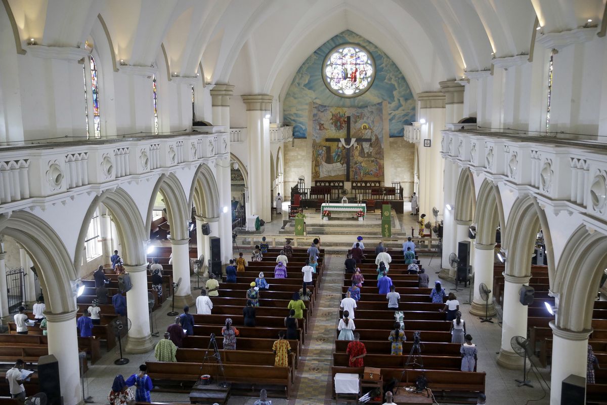 The congregation practices social distancing to curb the spread of the coronavirus during a Sunday mass at the Holy Cross Cathedral last week in Lagos, Nigeria.  (Sunday Alamba)