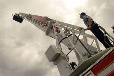
Lt. Bryan Johnson extends the giant ladder of the new Kootenai County Fire and Rescue truck stationed in Post Falls. 
 (Jesse Tinsley photos/ / The Spokesman-Review)