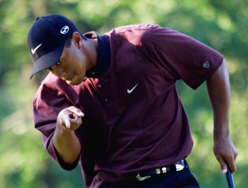 FILE - In this Aug. 20, 2000 file photo, Tiger Woods points to his ball as it drops for birdie on the first hole of a three-hole playoff against Bob May at the PGA Championship at the Valhalla Golf Club in Louisville, Ky. On his web site Friday night, Dec. 11, 2009, Woods announced that he is taking an indefinite break from professional golf. (Chuck Burton / Associated Press)