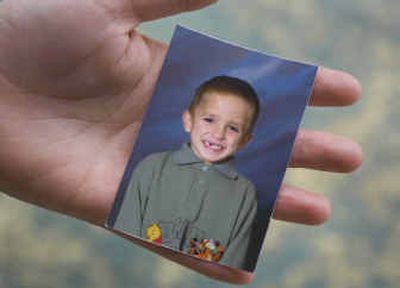 
A friend holds a school photo of Tyler DeLeon,  who died in January on his seventh birthday. An investigation by the Stevens County Sheriff's Office is focusing on his mother and her daughter.
 (Christopher Anderson/ / The Spokesman-Review)