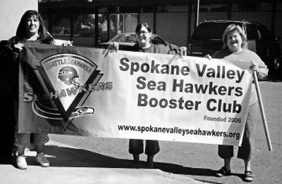 
Spokane Valley Sea Hawkers, from left, Monica Hickman, Nicki Sturckler and Barb Kolbet  show off the new club's banner.  The Spokane Valley chapter has nearly  60 members  and offers convenient meeting and game-watching venues for fans from Spokane Valley and North Idaho.
 (JULI Wasson / The Spokesman-Review)