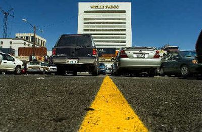 
Prium Companies has purchased this parking lot between Wall and Howard streets in downtown Spokane and plans to build a 15-story condominium tower with parking and ground-floor retail.
 (Christopher Anderson / The Spokesman-Review)