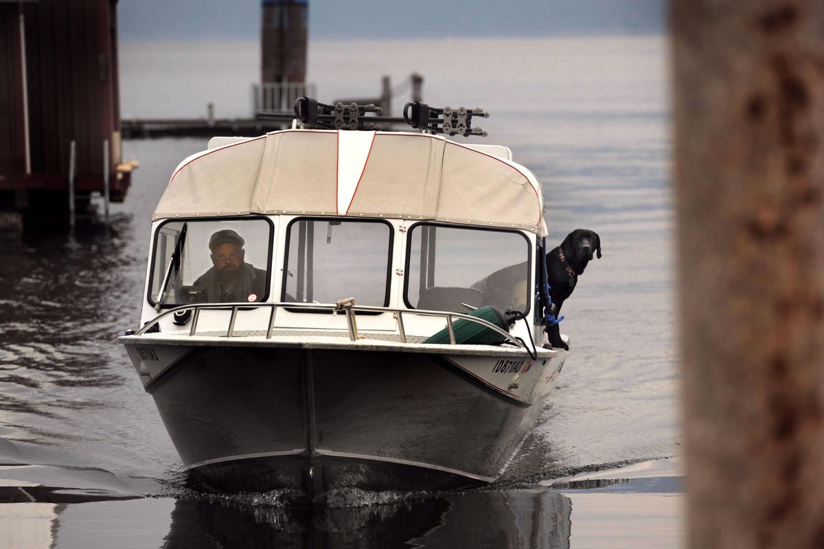 Captain Wes Jones and his dog Hank set out to deliver the mail on Lake Pend Oreille in Bayview on Wednesday, Nov. 14, 2018. (Kathy Plonka / The Spokesman-Review)