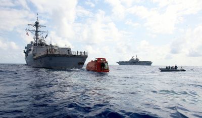This photo provided by the U.S. Navy on Tuesday shows the USS Bainbridge towing the lifeboat from the Maersk Alabama to be processed for evidence after the rescue of Capt. Richard Phillips. (AP / The Spokesman-Review)