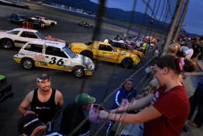 
Racers distribute candy to fans at Stateline Speedway during a break in racing  in June. 
 (File / The Spokesman-Review)