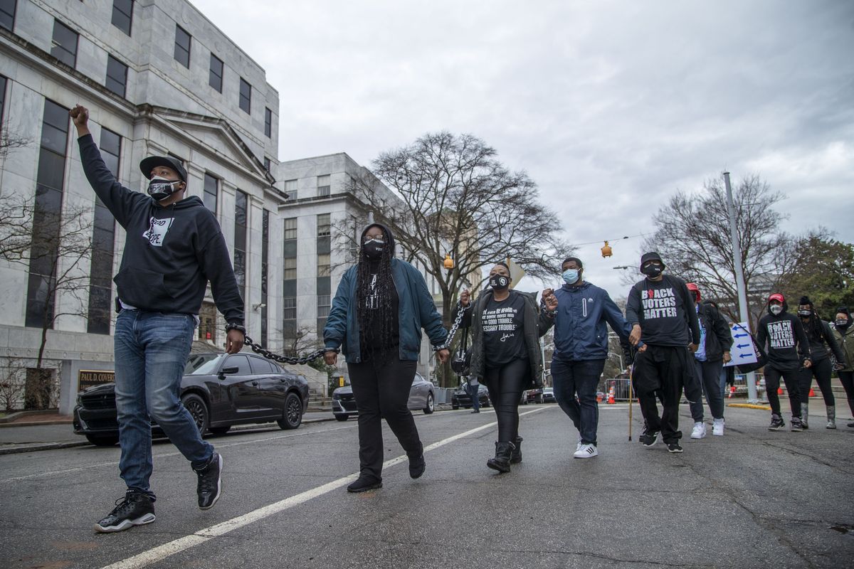 Demonstrators chained together protest HB 531 outside of the Georgia State Capitol Building on day 25 of the legislative session in Atlanta, Monday, March 1, 2021.  (Alyssa Pointer)