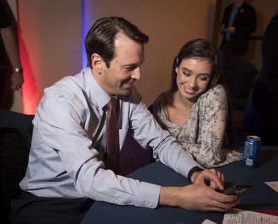 FILE – State Sen. Andy Billig, D-Spokane, looks for early results of the November 2016 election with his daughter Bella, 16, during the Democrat's election night party at The Lincoln Center. (Colin Mulvany / The Spokesman-Review)