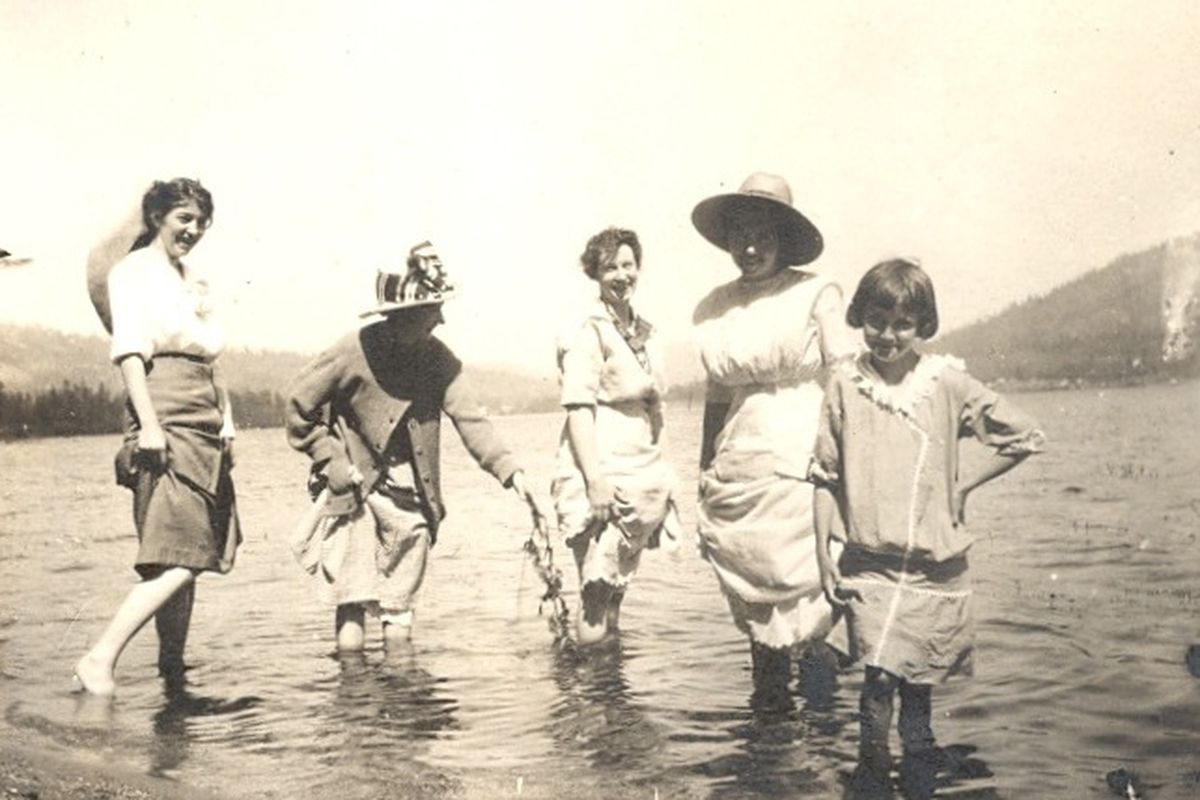 The King sisters, along with young friend Aleen Ritter, get their feet wet in Loon Lake, Wash., July 1914.