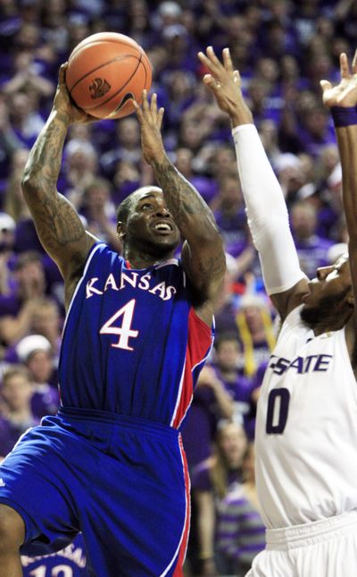 Kansas guard Sherron Collins shoots over Kansas State guard Jacob Pullen during the first half of the Jayhawks’ win Saturday.  (Associated Press)