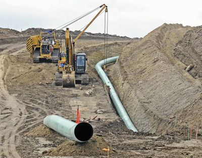 In this Oct. 5, 2016, photo, heavy equipment is seen at a site where sections of the Dakota Access pipeline were being buried near the town of St. Anthony in Morton County, N.D. The 1,200-mile line carrying North Dakota oil through South Dakota and Iowa to a distribution point in Illinois began commercial service Thursday. (Tom Stromme / Associated Press)