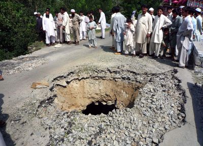 Local residents look at a portion of a bridge damaged by Islamic militants with explosives Thursday in Khawaza Khela near Mingora, the main town of Pakistan’s Swat Valley.  (Associated Press / The Spokesman-Review)