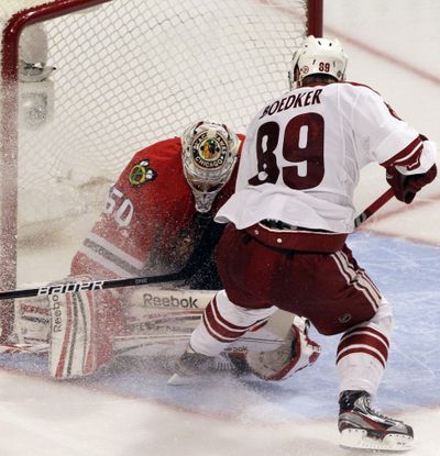 Coyotes’ Mikkel Boedker scores winning goal in overtime against Blackhawks goalie Corey Crawford for second consecutive game. (Associated Press)