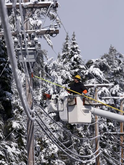 A worker with Central Maine Power Co. resets a circuit in Harpswell, Maine, restoring power to the area on Monday.  (Associated Press / The Spokesman-Review)