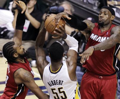 Miami’s Ronny Turiaf, left, watches as teammate LeBron James blocks a shot by Indiana’s Roy Hibbert during the Pacers’ win. (Associated Press)