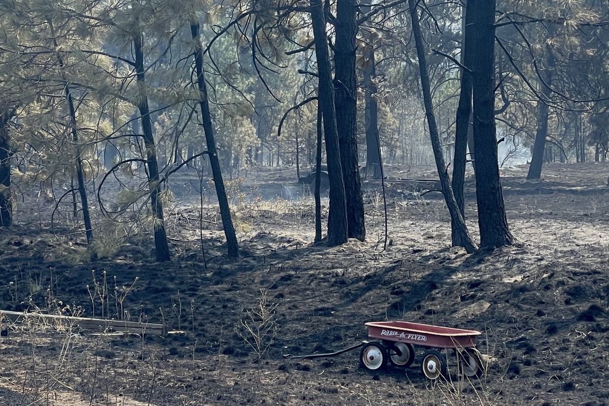 A Radio Flyer wagon lies abandoned on a property off Columbia Basin Highway following a 220-acre wildfire Friday, July 26, 2024.  (Alexandra Duggan / The Spokesman-Review)