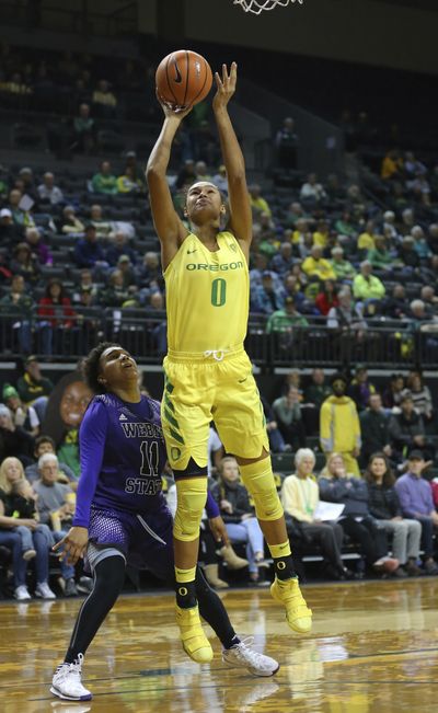 Oregon’s Satou Sabally shoots over Weber State defender Larryn Brooks during an NCAA college basketball game in Eugene, Ore., Saturday, Dec. 2, 2017. (Brian Davies / Register-Guard via AP)