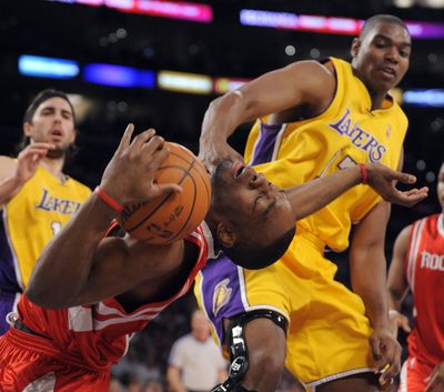 Lakers center Andrew Bynum fouls Houston forward Carl Landry.  (Associated Press / The Spokesman-Review)