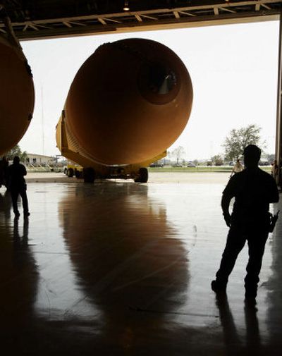 
A space shuttle external fuel tank is towed into NASA'S Michoud Assembly Facility in New Orleans Monday. 
 (Associated Press / The Spokesman-Review)
