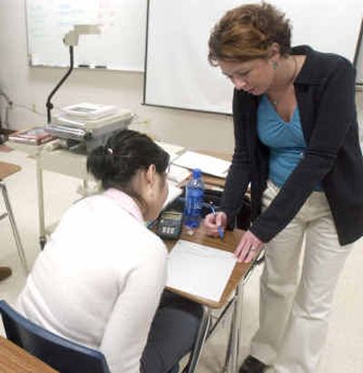 
Teacher Janeal Lee, right, helps students in an advanced algebra class in Appleton, Wis., on Feb. 4. 
 (Associated Press / The Spokesman-Review)