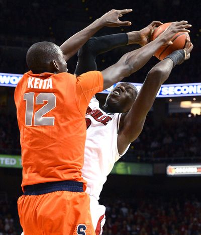 Louisville’s Gorgui Dieng, right, is blocked by Syracuse’s Baye Moussa Keita during the Orange’s upset win over No. 1 Cardinals. (Associated Press)