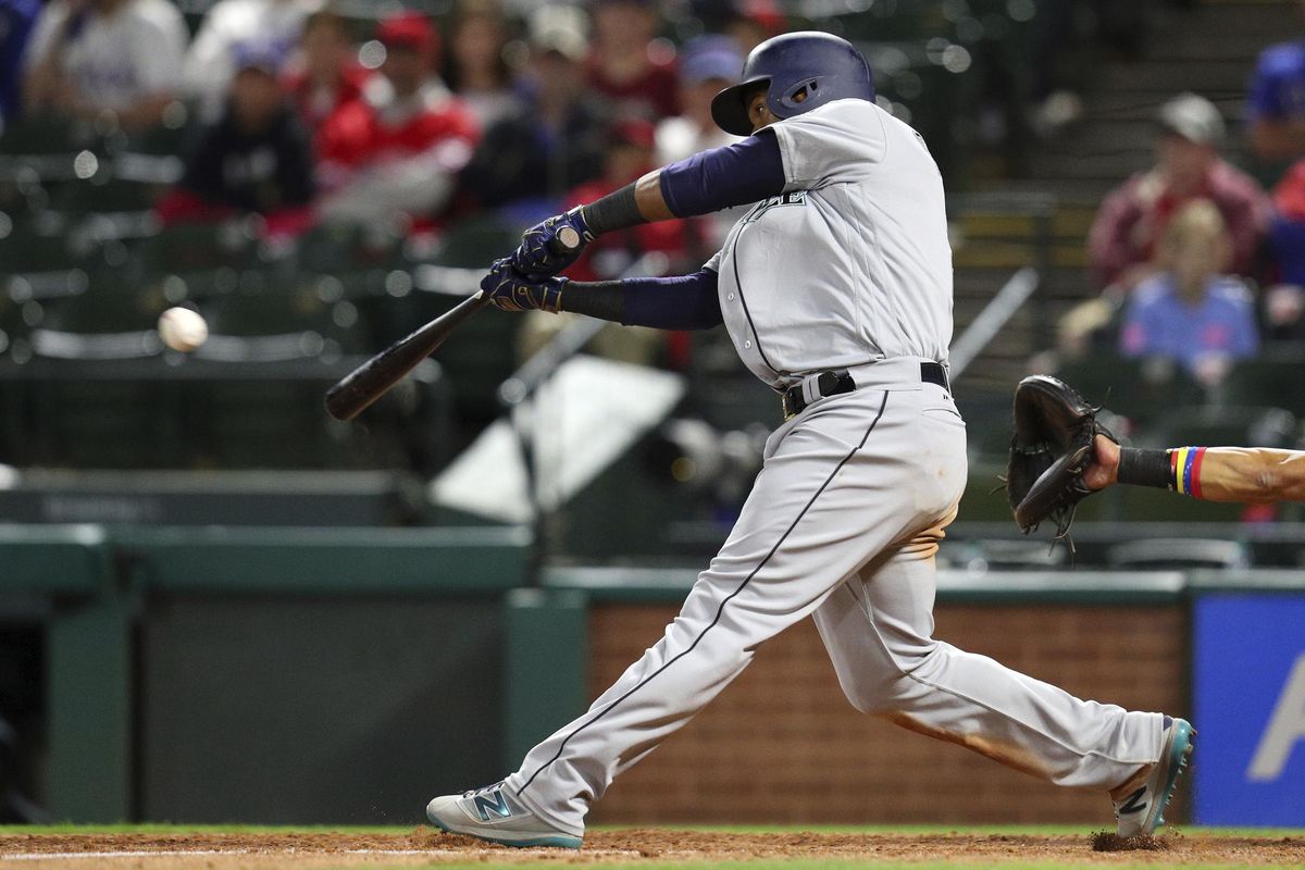Jean Segura of the Mariners hits a two-run double in the ninth inning against the Texas Rangers in a baseball game Friday, April 20, 2018, in Arlington, Texas. The play gave the Mariners a 4-2 lead. (Richard W. Rodriguez / Associated Press)