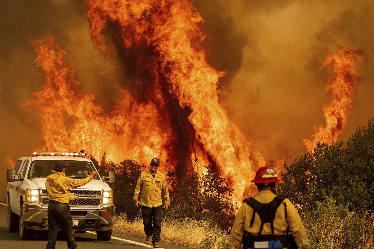Flames from the LNU Lightning Complex fires leap above Butts Canyon Road on Sunday, Aug. 23, 2020, as firefighters work to contain the blaze in unincorporated Lake County, Calif. (Noah Berger)