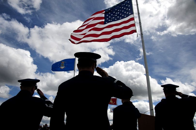 Members of the 560th Air Force Band/Air National Guard of the Northwest, including, from left,  Senior Master Sgt. Michael Baker, Tech Sgt. David Volland, Major James Phillips, Master Sgt. Jaye Nordling salute the flag during the National Anthem, May 27, 2013 during the 3rd annual Memorial Day Ceremony at the Washington State Veterans Cemetery in Medical Lake, Wash.   (Dan Pelle)