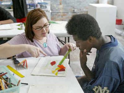 Jaquese Moultrie, 17, right, works with artist-in-residence Devanie Schilpp on a stained-glass project at an after school art program in Atlanta.
(Associated Press / The Spokesman-Review)