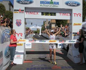 Julie Dibens celebrates the finish line of the 2011 Ford Ironman Coeur d'Alene Sunday afternoon in downtown Coeur d'Alene.  Bruce Twitchell/ Special to The Spokesman-Review
