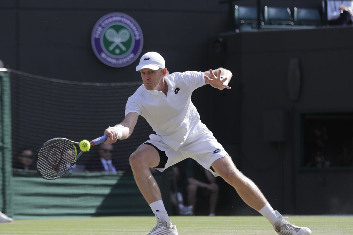 Kevin Anderson of South Africa returns the ball to Switzerland's Roger Federer during their men's quarterfinals match at the Wimbledon Tennis Championships, in London, Wednesday July 11, 2018. (Ben Curtis / AP)