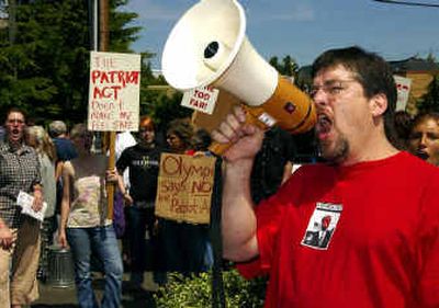 Olympia resident Zach Smith leads a group of protesters during an anti-Bush and anti-Patriot Act chant Thursday outside a Republican-sponsored Patriot Act conference in Olympia. The protesters were expressing their general opposition to the act and stressing their right to have their civil liberties protected.Olympia resident Zach Smith leads a group of protesters during an anti-Bush and anti-Patriot Act chant Thursday outside a Republican-sponsored Patriot Act conference in Olympia. The protesters were expressing their general opposition to the act and stressing their right to have their civil liberties protected.
(Associated PressAssociated Press / The Spokesman-Review)