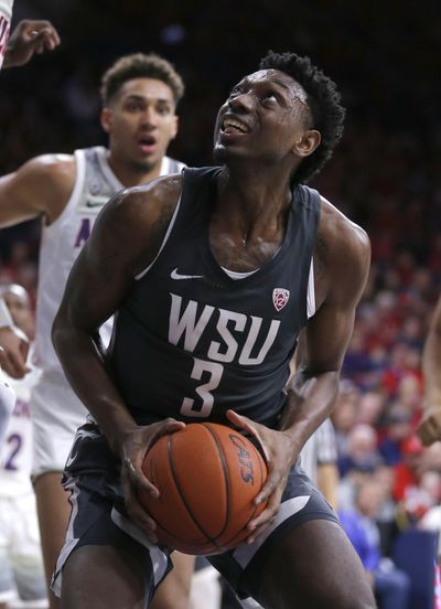 Washington State forward Robert Franks  looks for a shot during Saturday’s victory over  Arizona in Tucson, Ariz. (Rick Scuteri / AP)