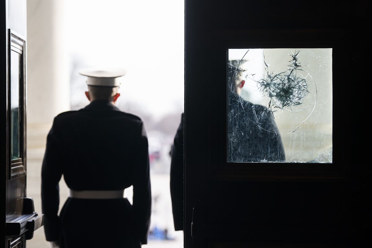 U.S. Marine Corps. sentries outside a damaged door at the Capitol during a rehearsal for the 59th inaugural ceremony for President-elect Joe Biden and Vice President-elect Kamala Harris on Monday, January 18, 2021 at the U.S. Capitol in Washington.  (Jim Lo Scalzo/Associated Press)