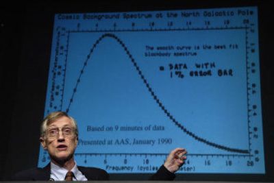 
John C. Mather, an astrophysicist at NASA's Goddard Space Flight Center, shows some of the earliest data from the Cosmic Background Explorer satellite during a news conference Tuesday.
 (Associated Press photos / The Spokesman-Review)