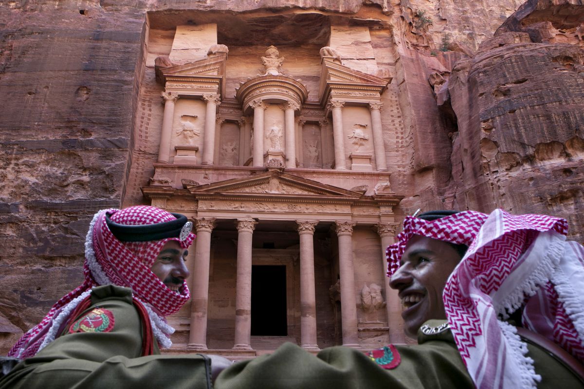 Jordanian royal desert forces stand guard in front of Al Khazneh, Arabic for the Treasury, the most dramatic of many facades carved into the mountains, in the ancient city of Petra, Jordan. (Associated Press)