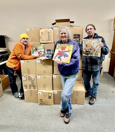 Volunteers Michael Sutcliffe, left, Sandy Gill and Mike Flahaven display a handful of the items that will be available for sale at the Spokane Public Radio record sale this weekend.  (Cynthia Reugh/For The Spokesman-Review)