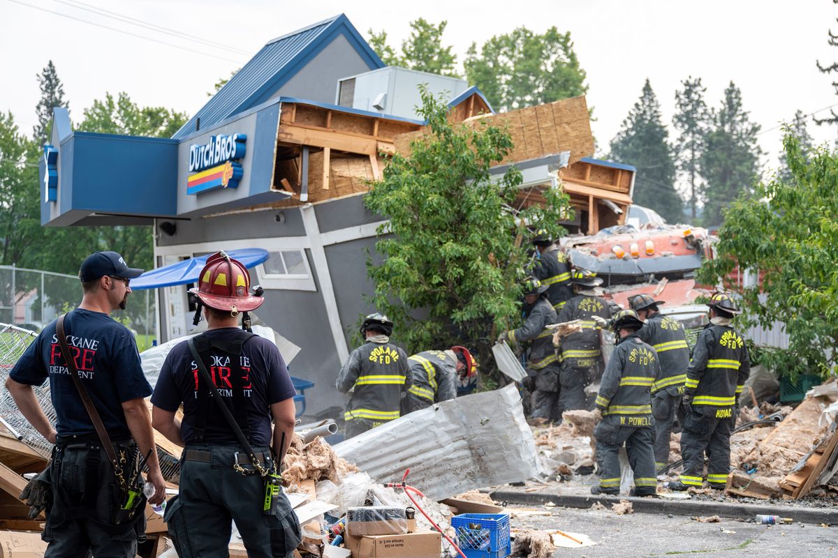 Seven people were taken to a hospital Friday after a dump truck slammed into a Dutch Brothers coffee drive-thru and another business at Fourth Avenue and Freya Street on Friday.  (COLIN MULVANY/THE SPOKESMAN-REVIEW)