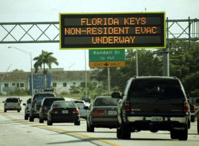 
Rush hour traffic travels past a sign announcing hurricane evacuation Thursday in Miami. Hurricane Dennis also prompted the Florida Keys to order an evacuation of some residents and all tourists.
 (The Spokesman-Review)