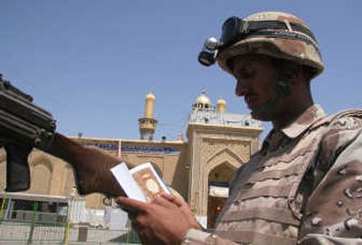 
An Iraqi soldier reads the Quran as he stands guard in front of the shrine of Imam Abbas in the Shiite holy city of Karbala on Wednesday. A new independent assessment concludes that Iraq's army shows the most promise of becoming a viable security force in the country. Associated Press
 (Associated Press / The Spokesman-Review)
