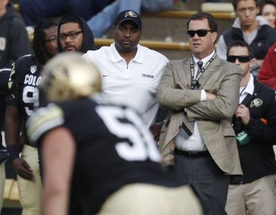 Colorado coach Jon Embree, left, confers with athletic director Mike Bohn during the Buffaloes’ 48-0 loss to Stanford on Nov. 3. (Associated Press)